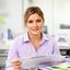 Property manager portrait in a bright office with a tablet and documents