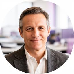 Portrait of Authur Rickstrom in a tailored jacket at a bright office desk